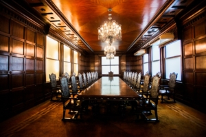 Private equity advisors negotiating MAC clause M&A agreement in boardroom