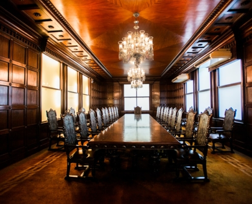 Private equity advisors negotiating MAC clause M&A agreement in boardroom