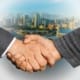 founder transitions business handshake deal closing formal suits